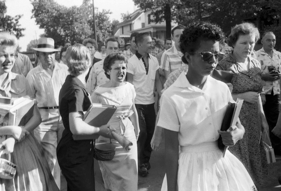 The Little Rock Nine being followed and threatened by an angry white mob in 1957.